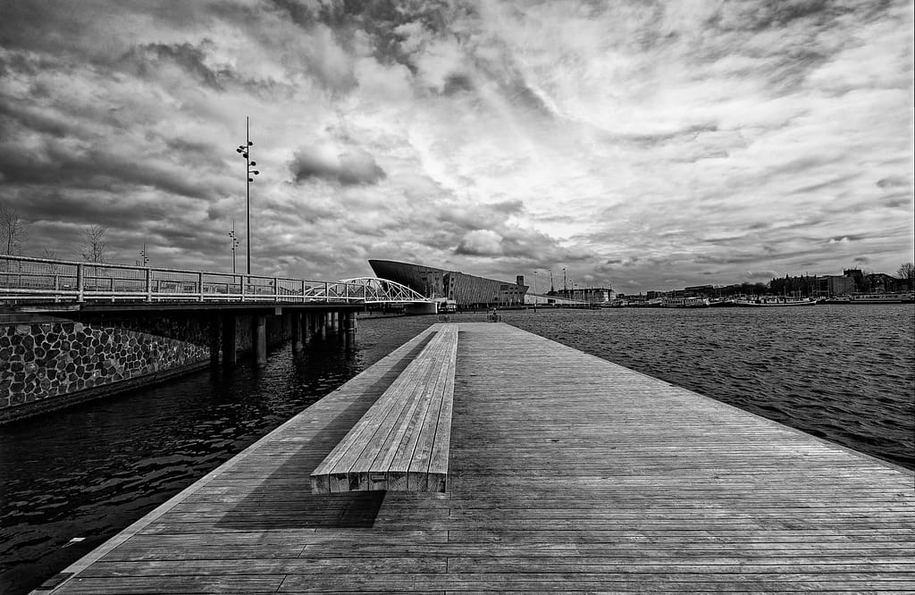 A jetty in the Oosterdok, Amsterdam with Nemo and the Scheepvaartmuseum in the distance. 2023.