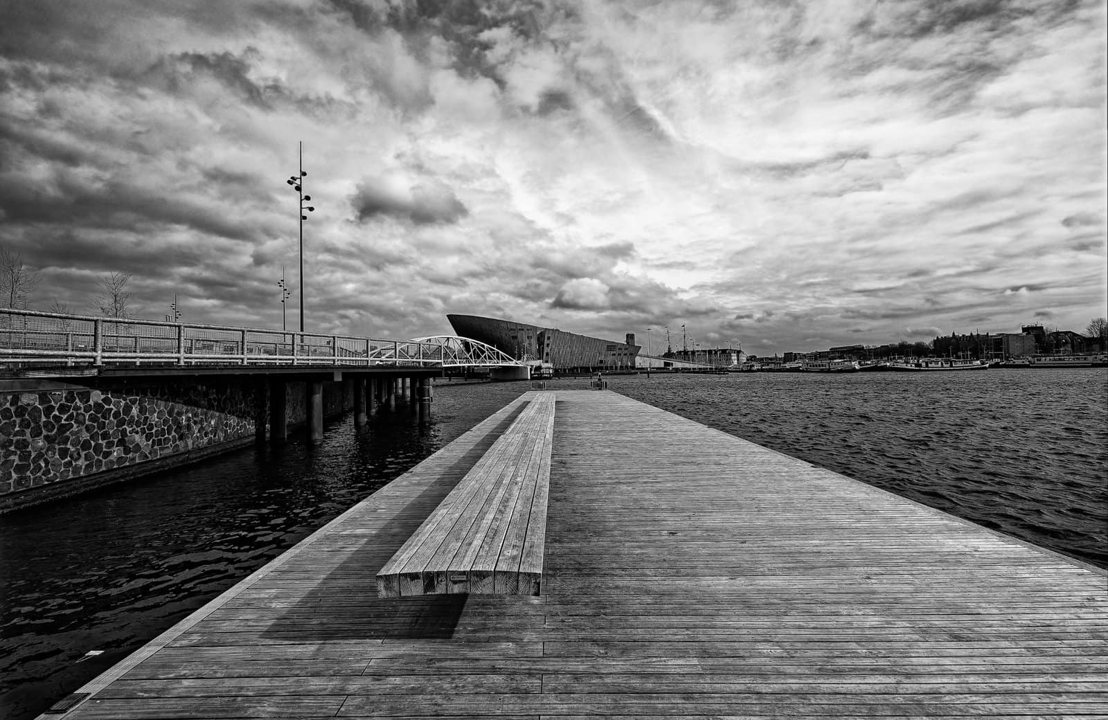 A jetty in the Oosterdok, Amsterdam with Nemo and the Scheepvaartmuseum in the distance. 2023.