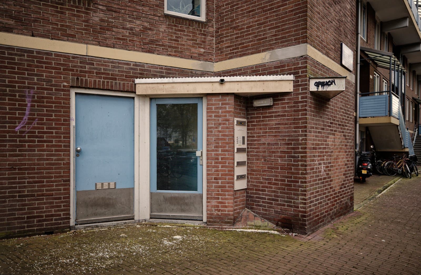 Pale Blue doors on a social housing flat in Amsterdam, 2024. part of the 'Unbeautiful Amsterdam Project'